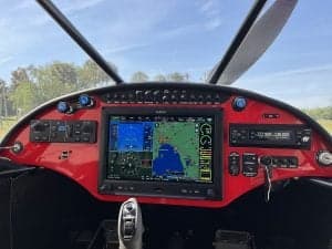 The cockpit of the aircraft features a large display screen and various controls.