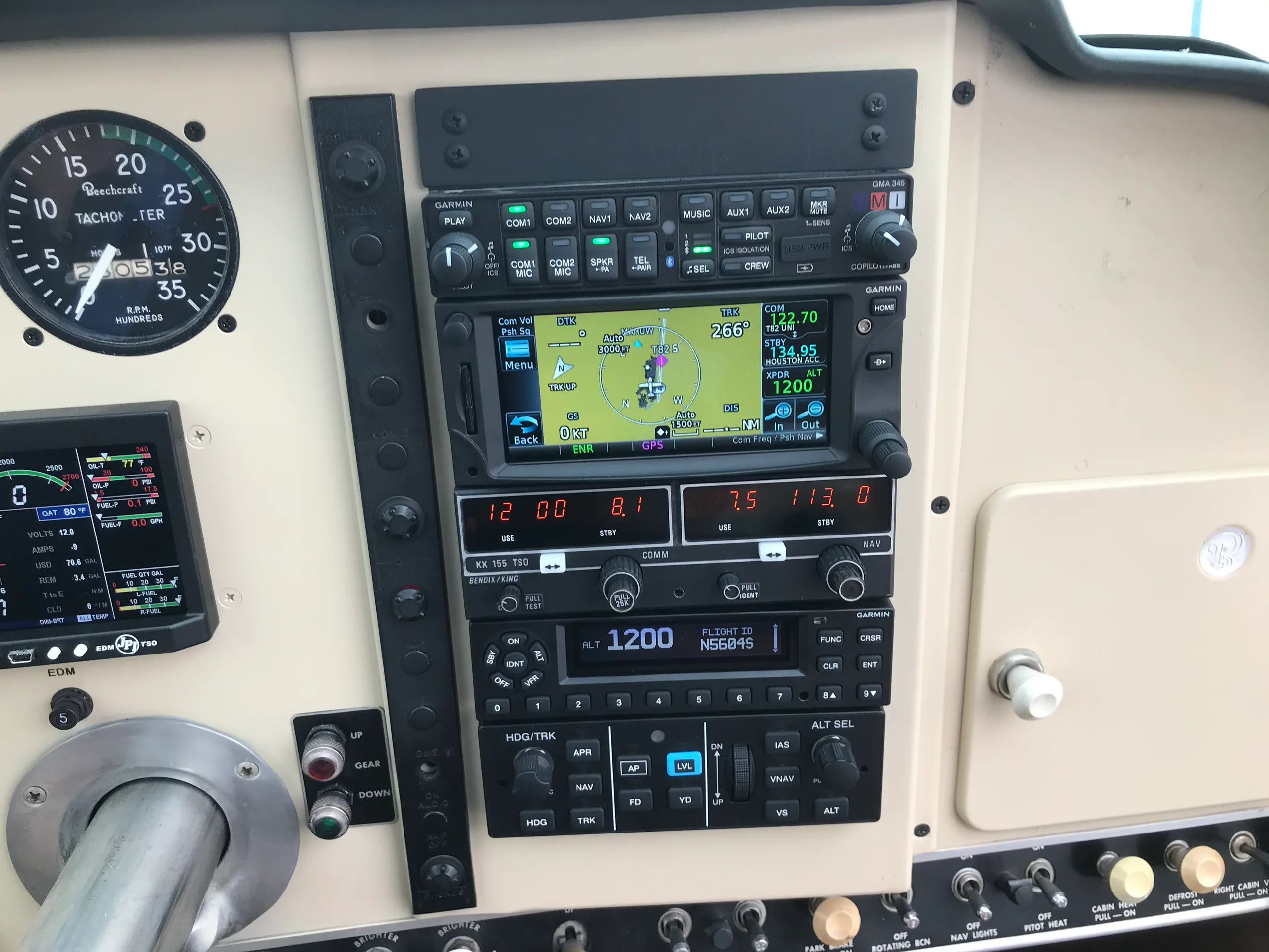 Close-up of the avionics stack in the cockpit of a Beechcraft V35 Bonanza aircraft.