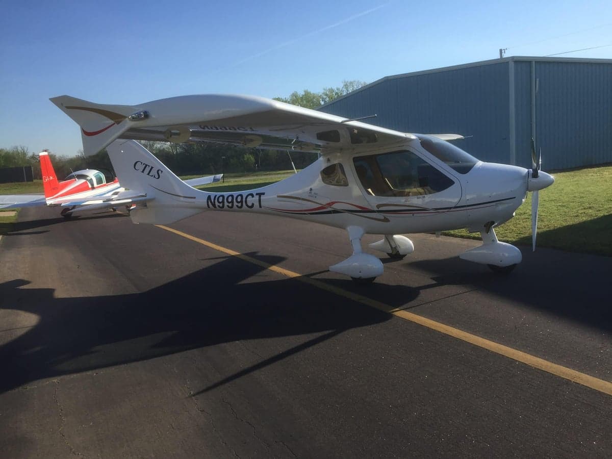 A white CTLS aircraft with registration N999CT is parked on the tarmac.