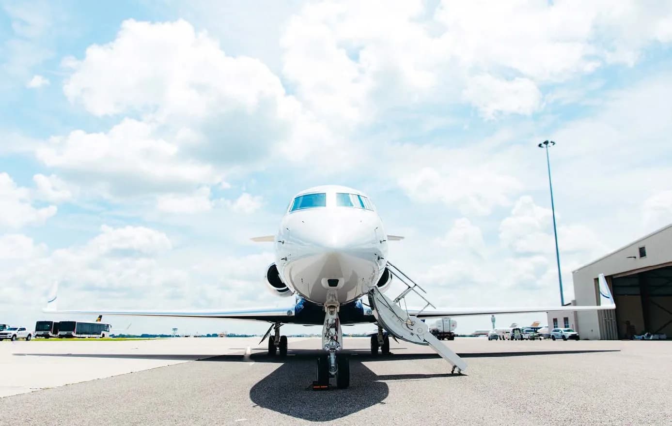 A head-on view of the Gulfstream G550 business jet, registration N279WR, parked on the tarmac with its main door open.