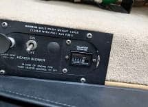 Close-up of the helicopter's heater blower switch and hour meter.