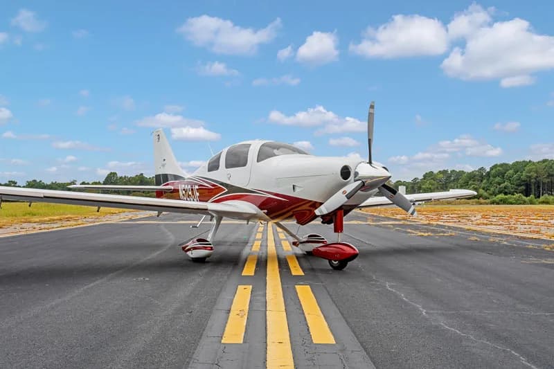 The Cirrus SR22 aircraft N529JF is parked on the runway.