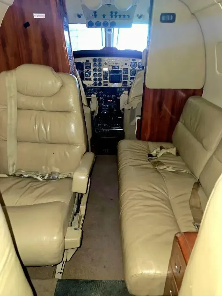 View of the aircraft's cabin seats and cockpit.