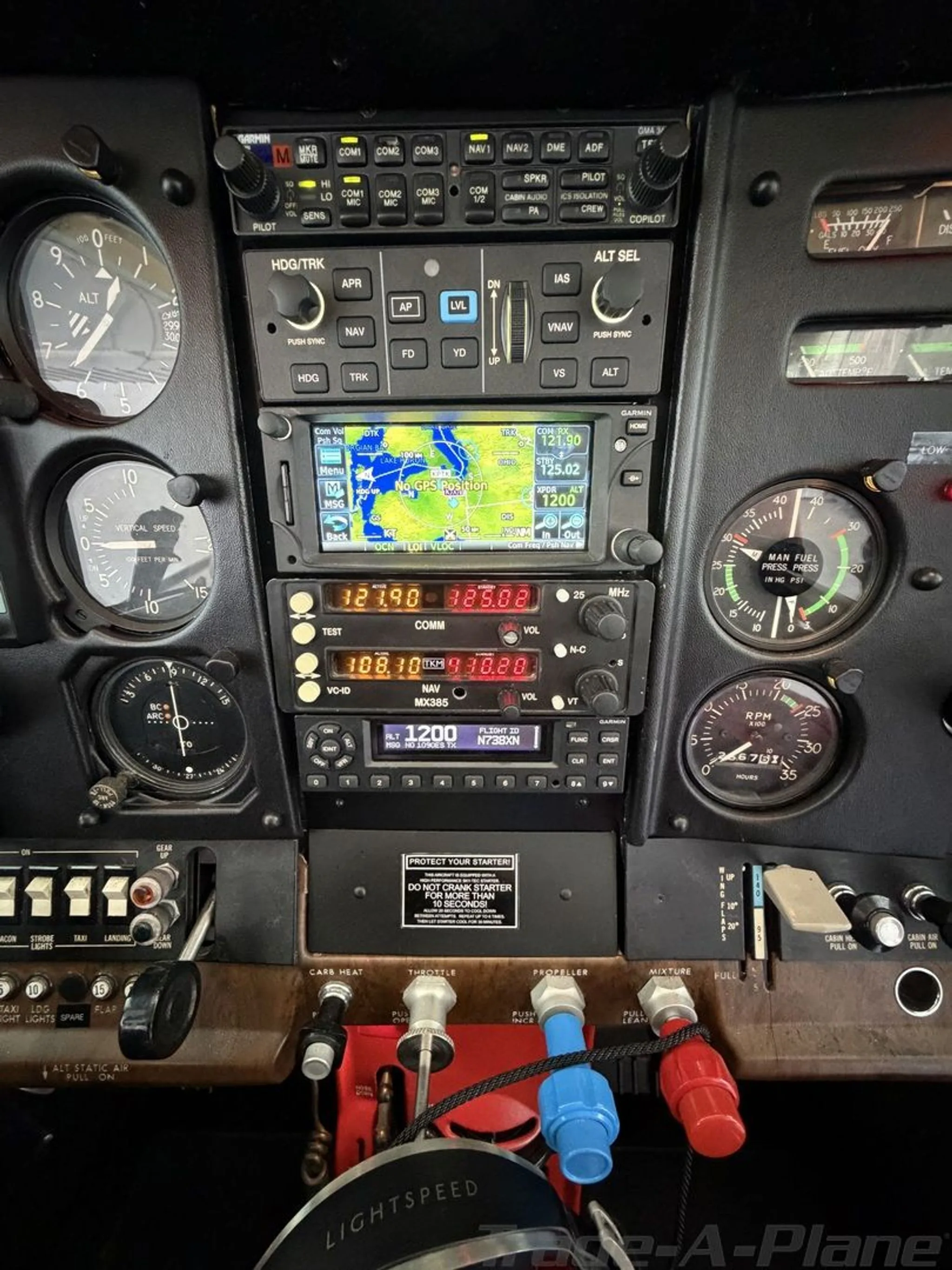 A close-up view of the central instrument panel with avionics and engine controls.