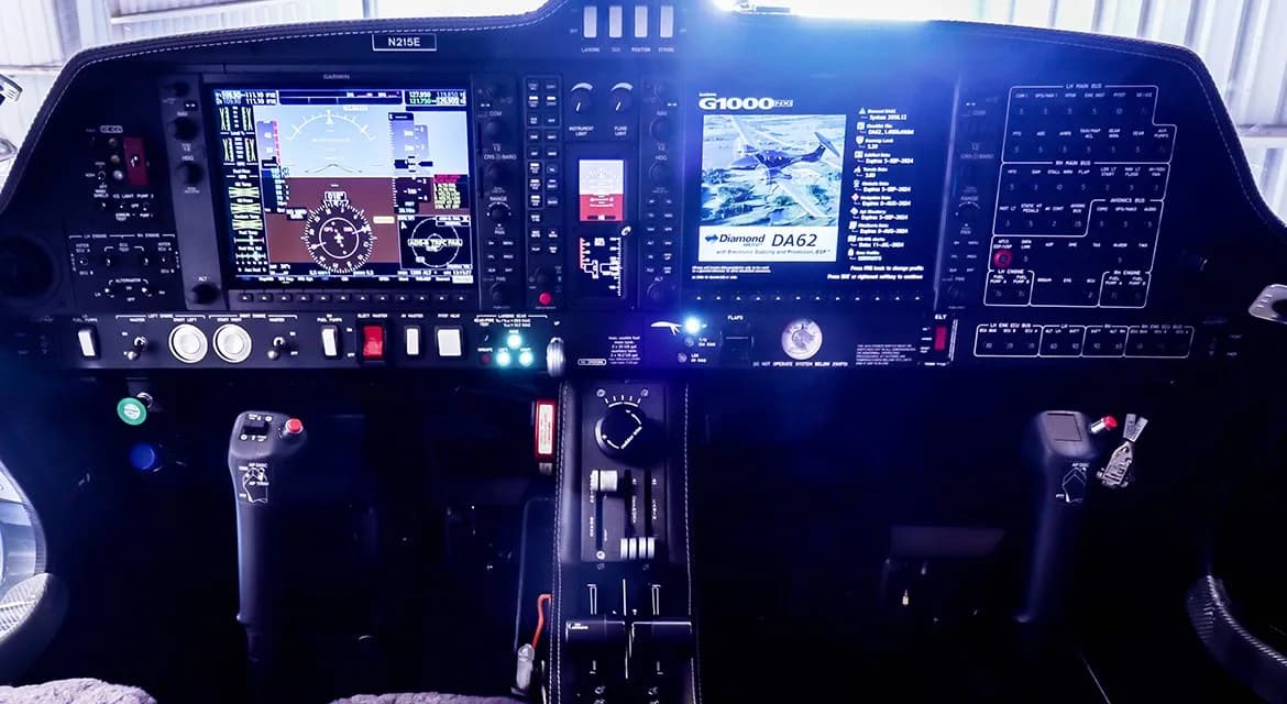 The illuminated cockpit instrument panel of a Diamond DA62 aircraft, featuring Garmin G1000 displays.