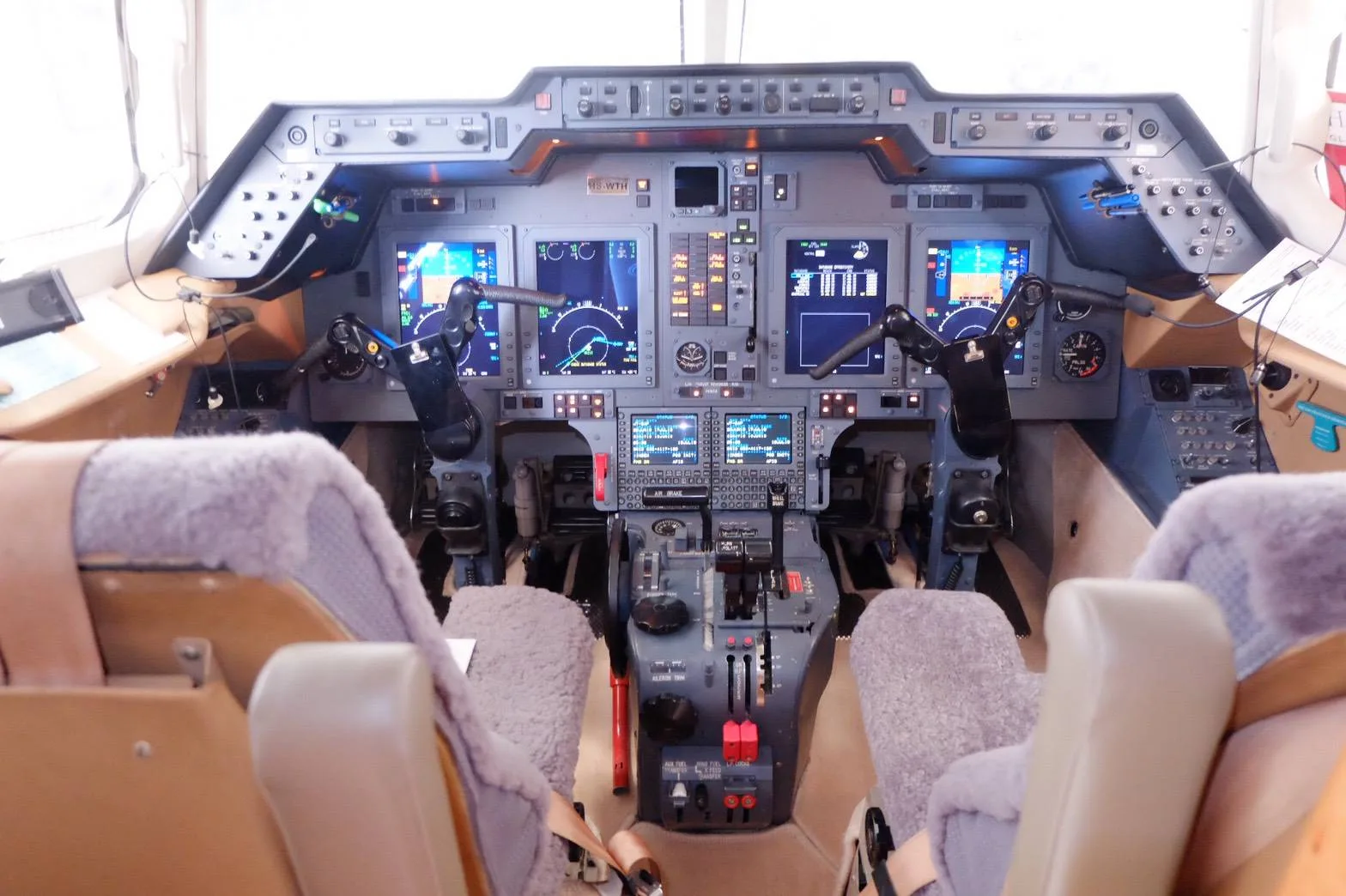 View of the cockpit instrument panel and seats of the aircraft.