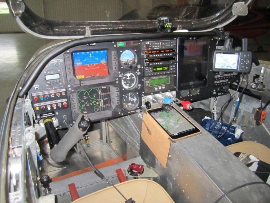The cockpit of an aircraft featuring various instruments and displays.