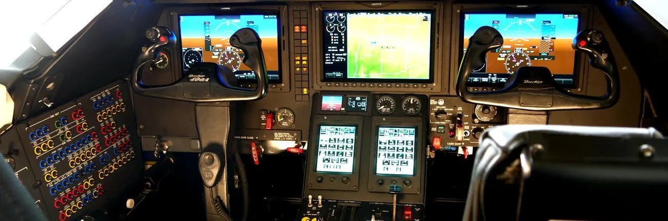 The cockpit of a Beechjet 400A with multiple digital displays and control yokes.