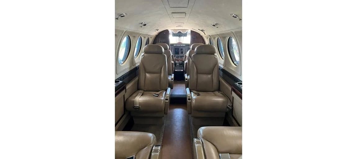 Aircraft cabin with forward-facing leather seats.