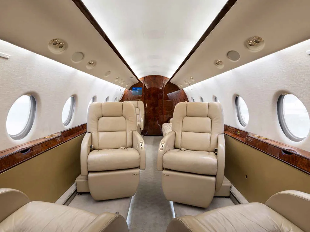 A view of the Gulfstream G450 cabin interior featuring two rows of beige leather club seats.