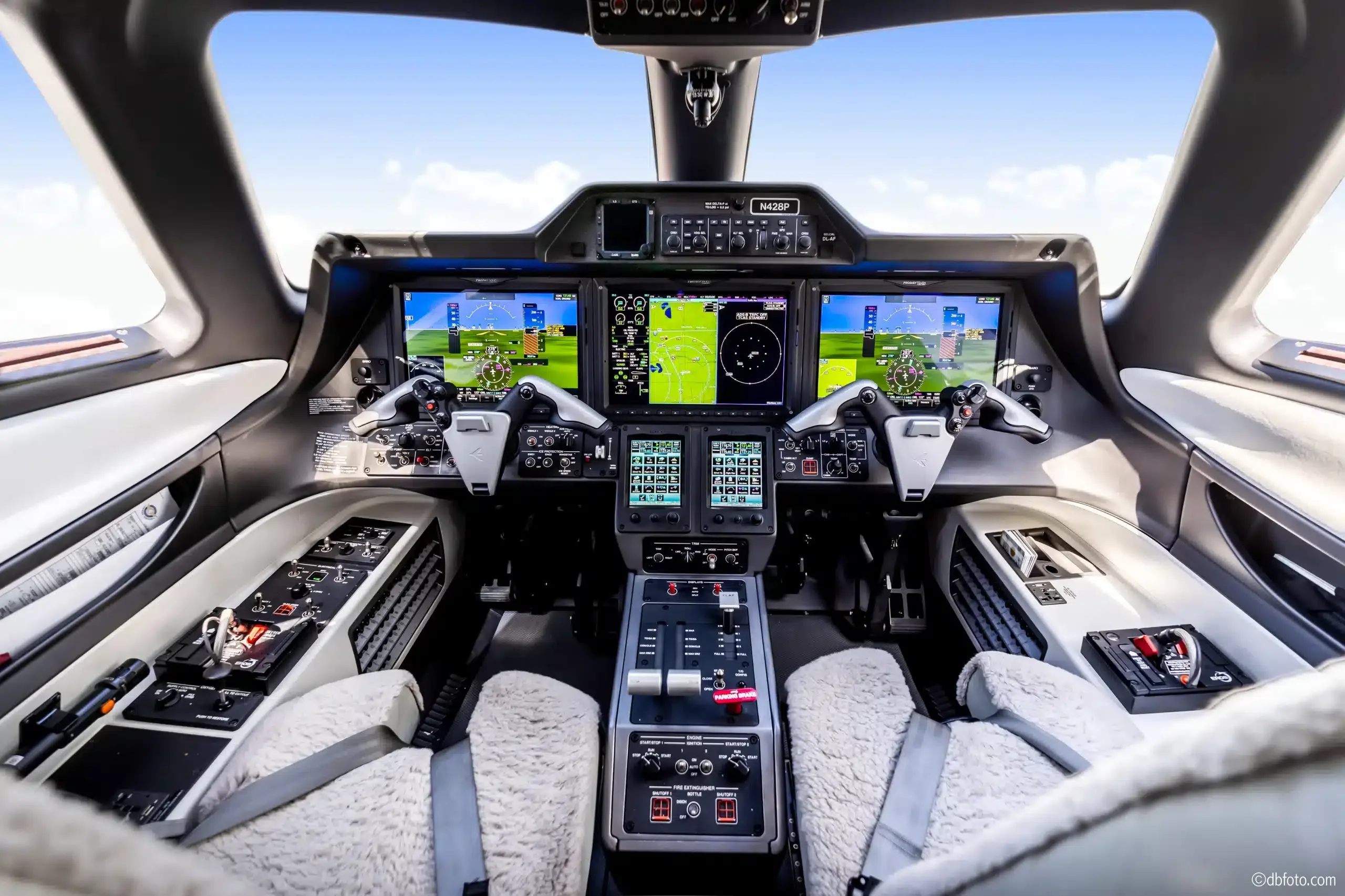 Aircraft cockpit with instrument panel and seats.