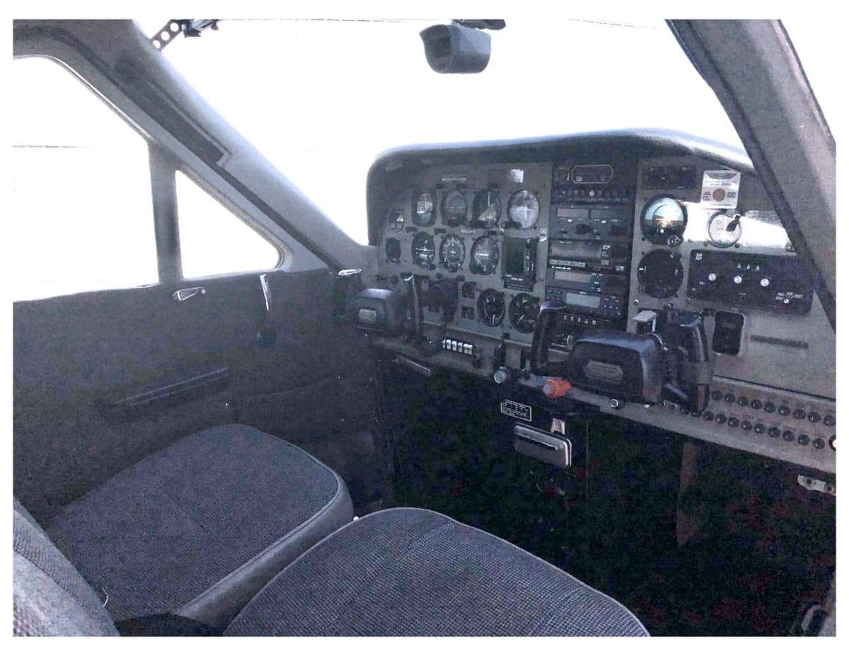 View of the cockpit seats and instrument panel from inside the aircraft.