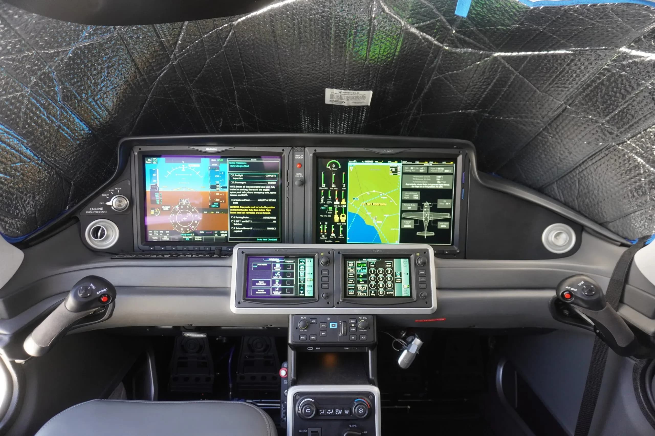 The cockpit of the aircraft features a modern glass panel display.
