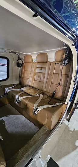 A view of the tan leather seats in the helicopter cabin.