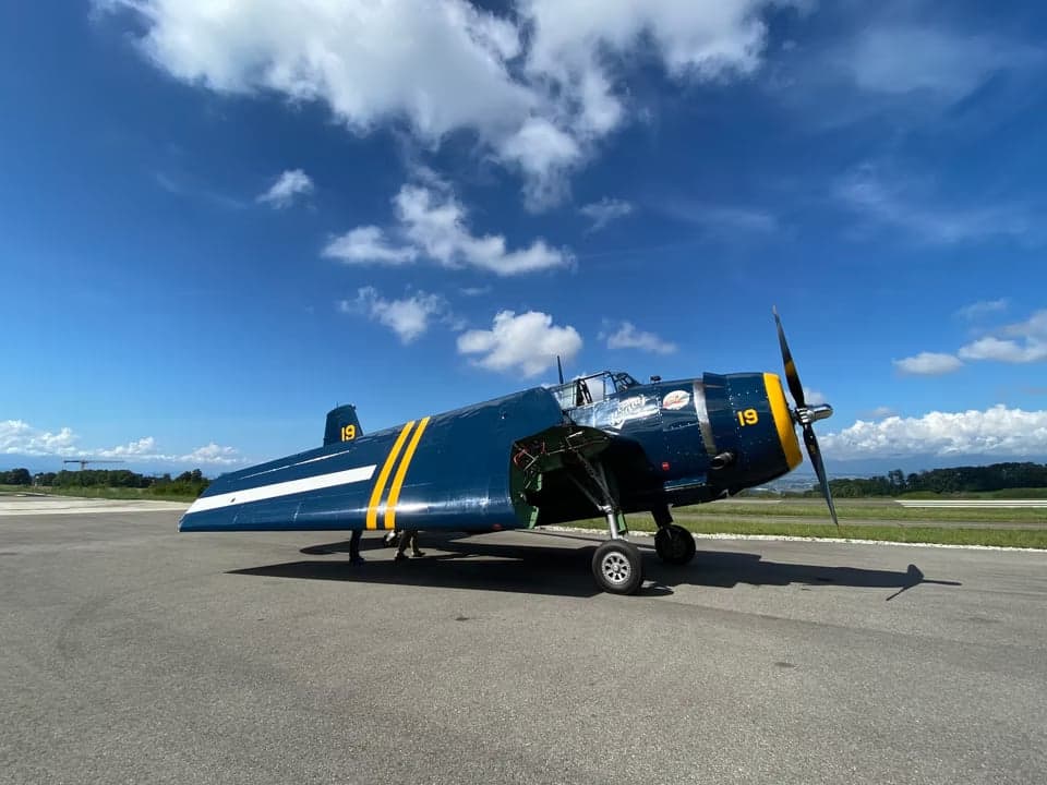 Grumman TBF Avenger in flight over water.