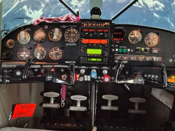 The cockpit of a Maule aircraft, showing the instrument panel, yokes, and controls.