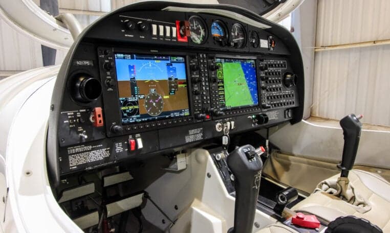 The cockpit of a Diamond DA40 aircraft features a modern glass panel.
