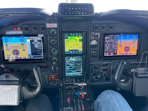 View of the aircraft's cockpit instrument panel with multiple displays.
