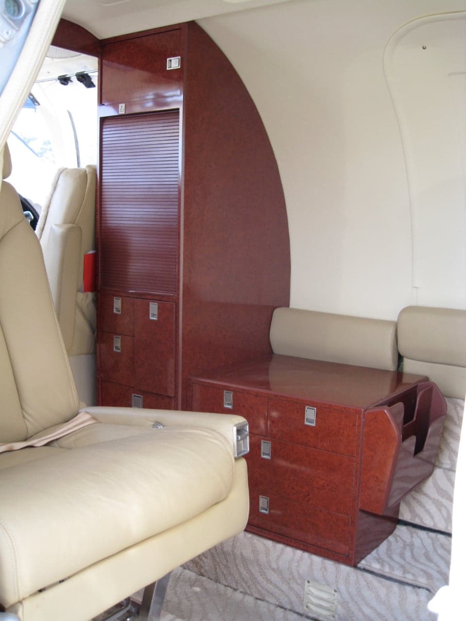View of the Cessna Citation CJ1 cabin with storage and seats.