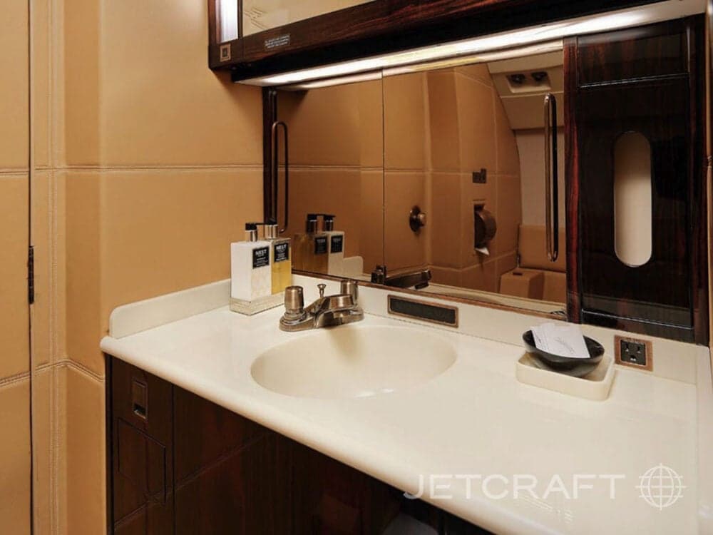 Aircraft lavatory with sink and toiletries.