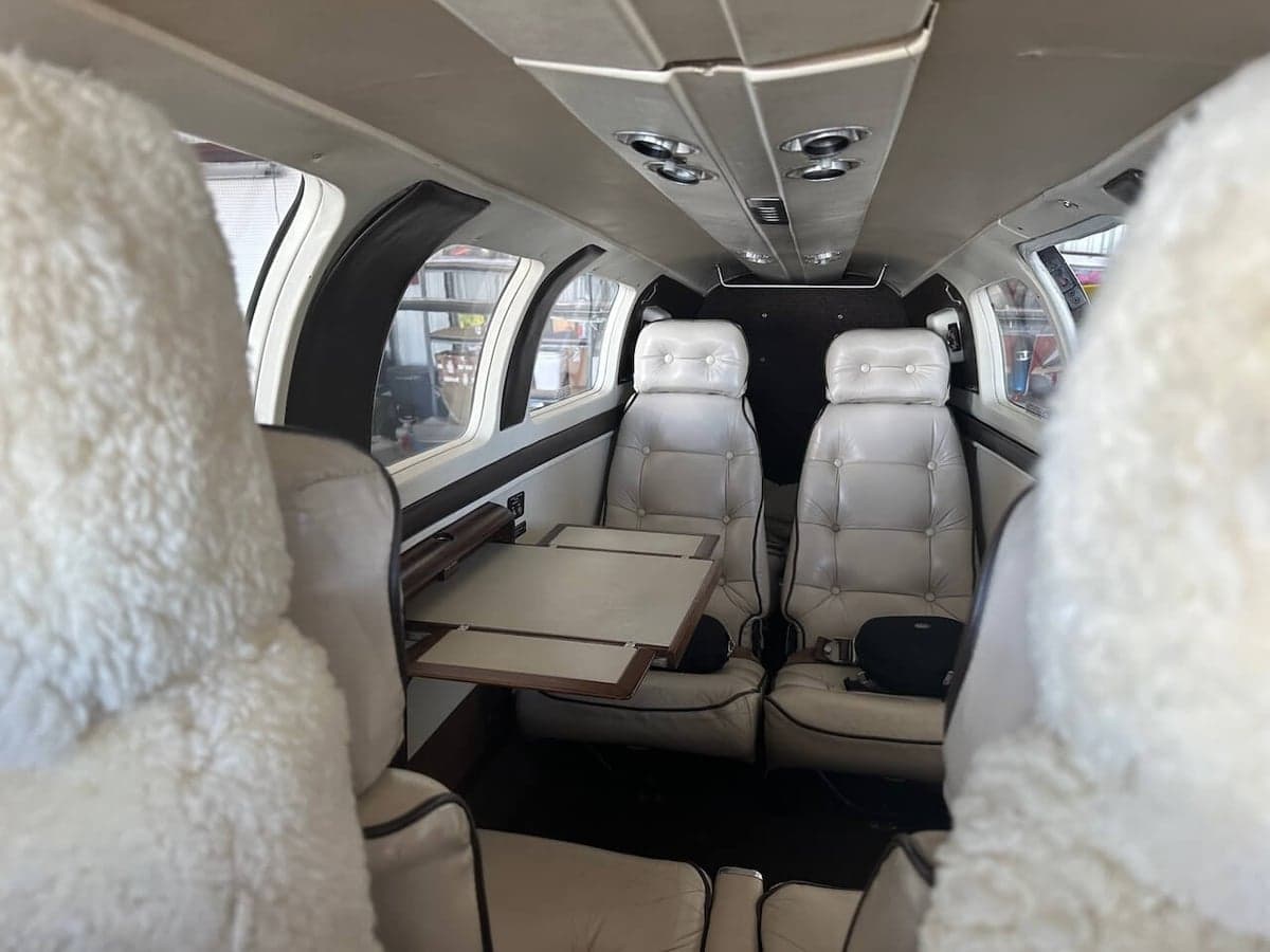 The interior of a Piper PA-31-350 Navajo Chieftain, showing the seating arrangement and cabin features.