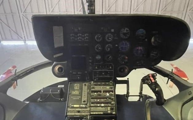 Helicopter interior with seats and medical equipment.