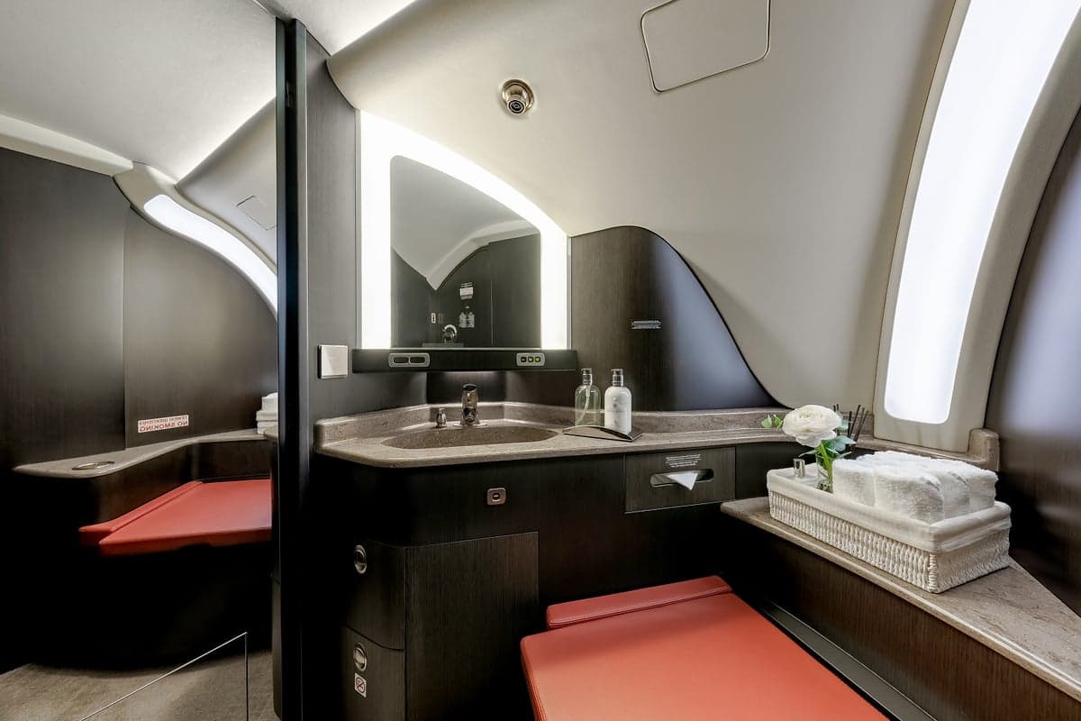 View of the aircraft interior with a bathroom and a neutral color scheme.