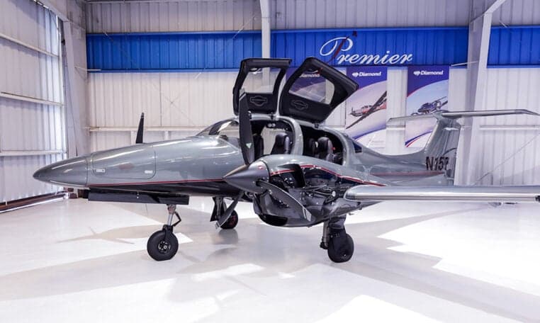 Diamond DA62 aircraft with open doors in a hangar.