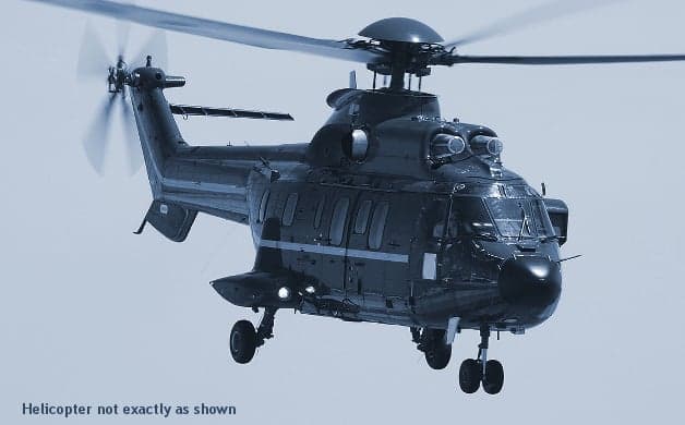 A Eurocopter AS332 Super Puma helicopter in flight.