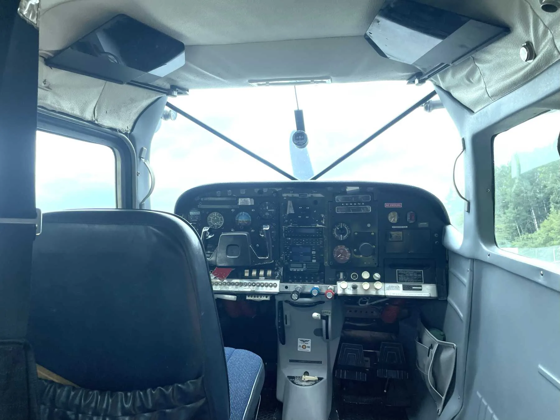 The cockpit of a Cessna 206 Stationair with a detailed instrument panel.