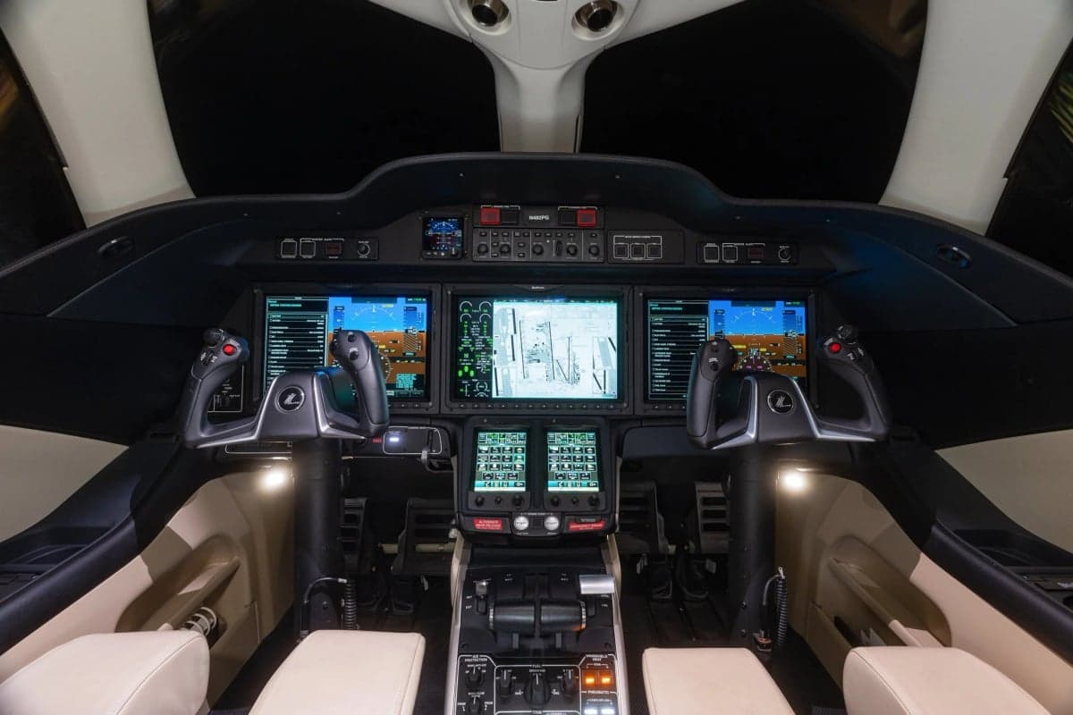View of the HondaJet cockpit with multiple display screens and controls.