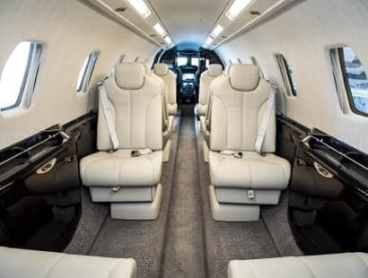 Side view of a white Cessna Citation Latitude on a black background.