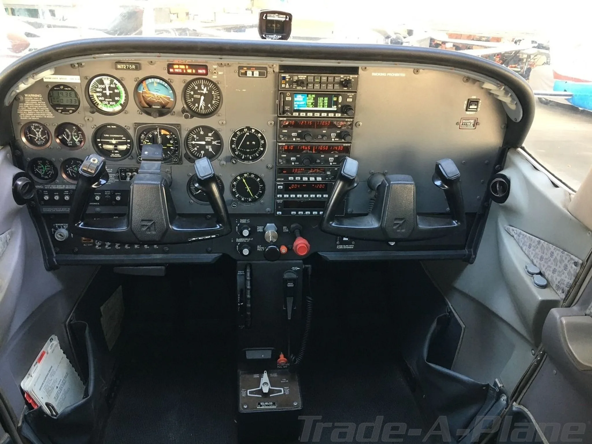 The cockpit of a Cessna 172SP Skyhawk, showing the instrument panel with analog gauges and avionics.