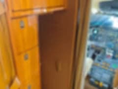 A blurry view of the Challenger aircraft cabin with beige leather seats.