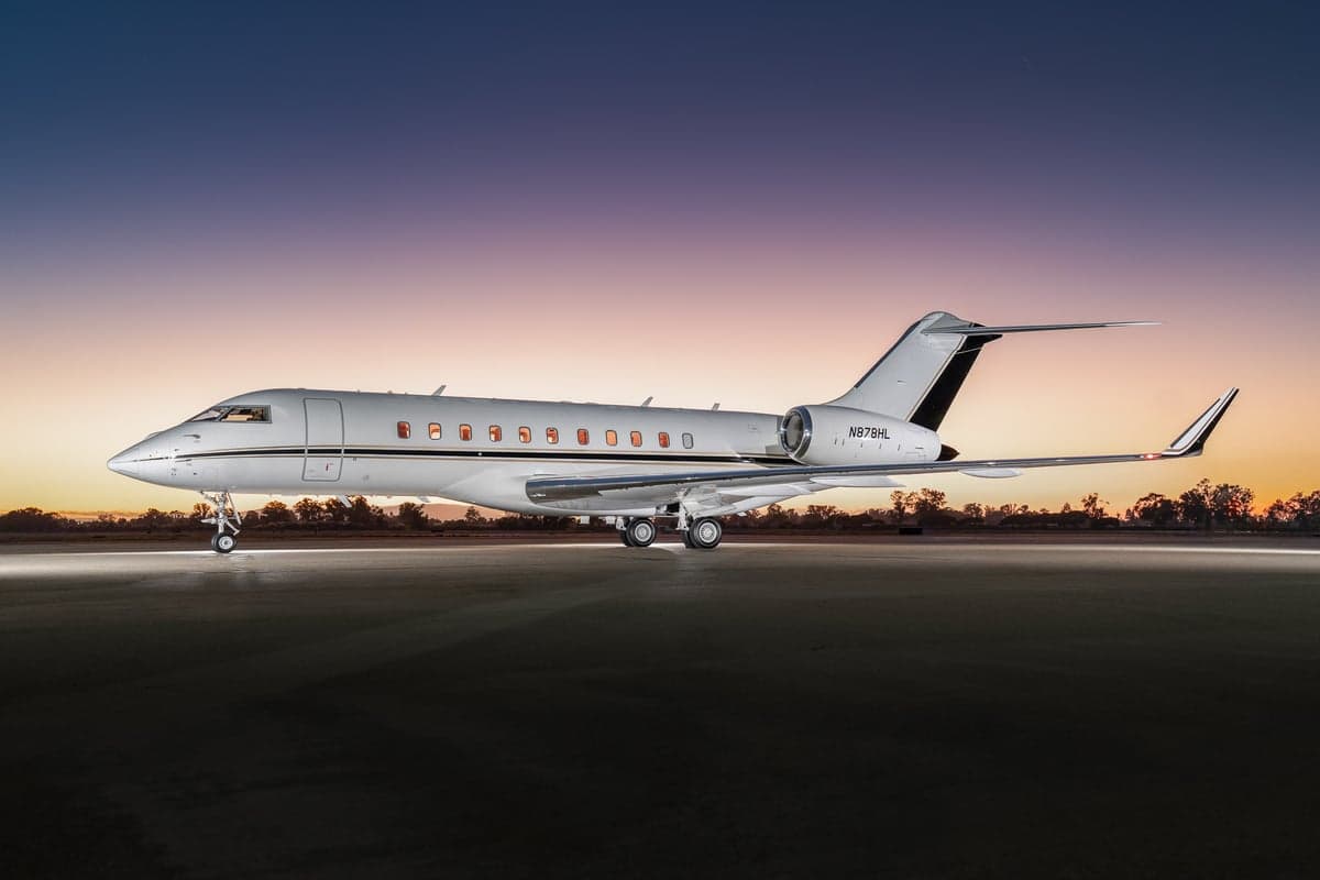 A Bombardier Global Express aircraft with registration N978HL parked on the tarmac at dusk.