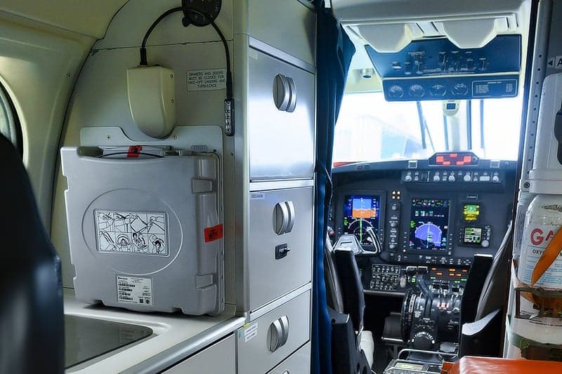 View of the cockpit with instrument panel and storage compartments.
