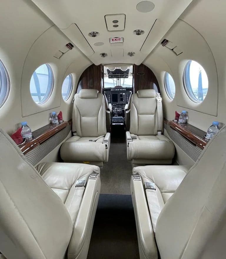 Forward view of the aircraft cabin with leather seats.