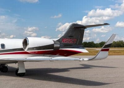 The tail of a Learjet 45XR aircraft is parked on the tarmac, showing the tail number.