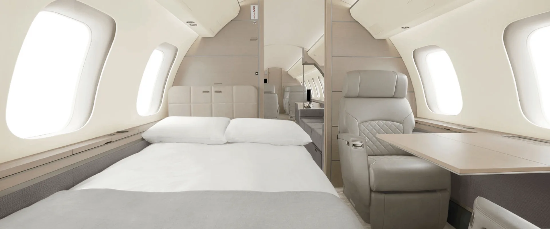 Aircraft cabin with bed and leather seat.