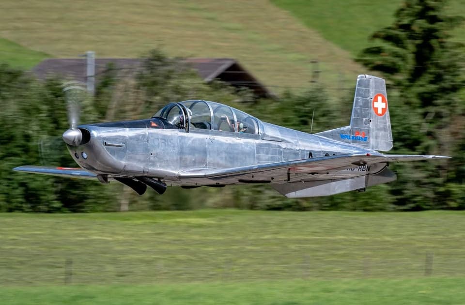 Formation of Pilatus PC-7 aircraft flying with contrails.