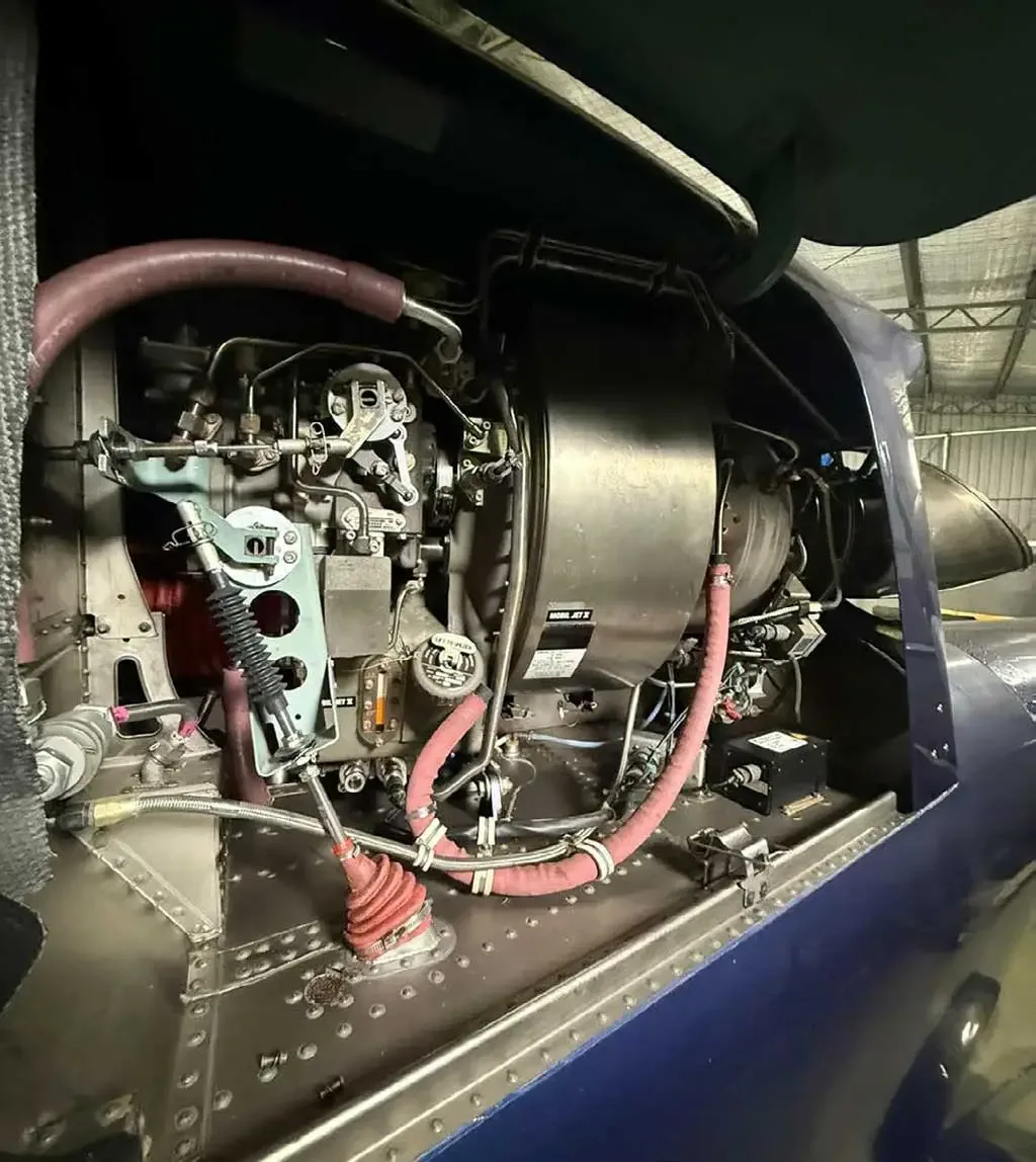 A detailed view of the complex engine and mechanical components inside a helicopter's bay.