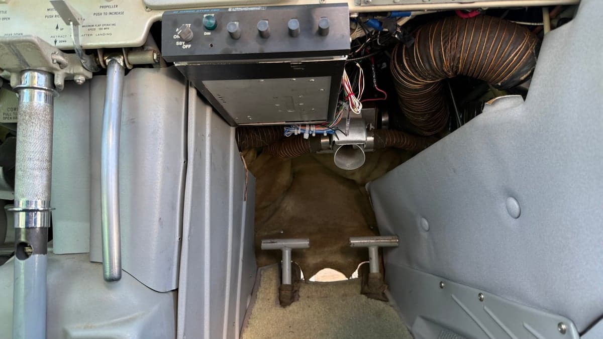 View of the rudder pedals and lower instrument panel of the aircraft.