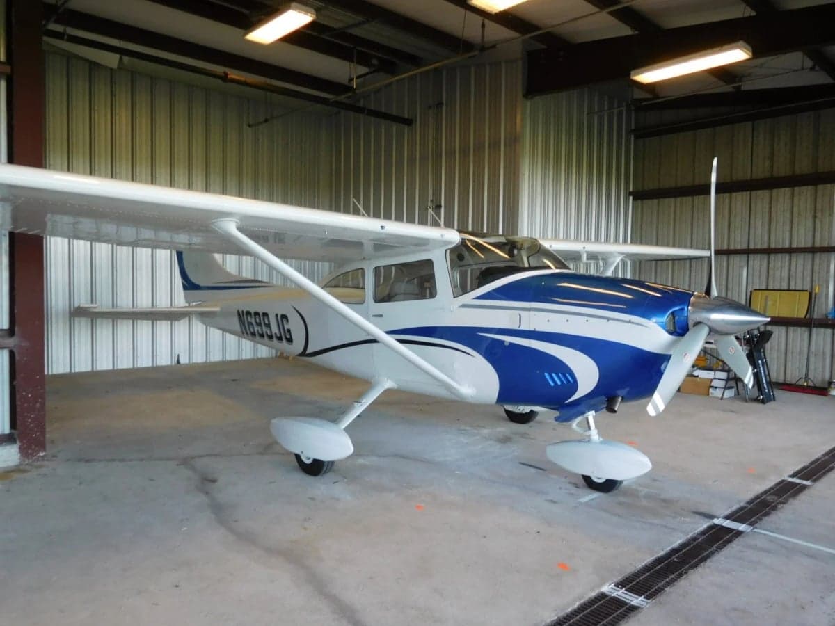 Side view of the N699JG Cessna aircraft inside a hangar.