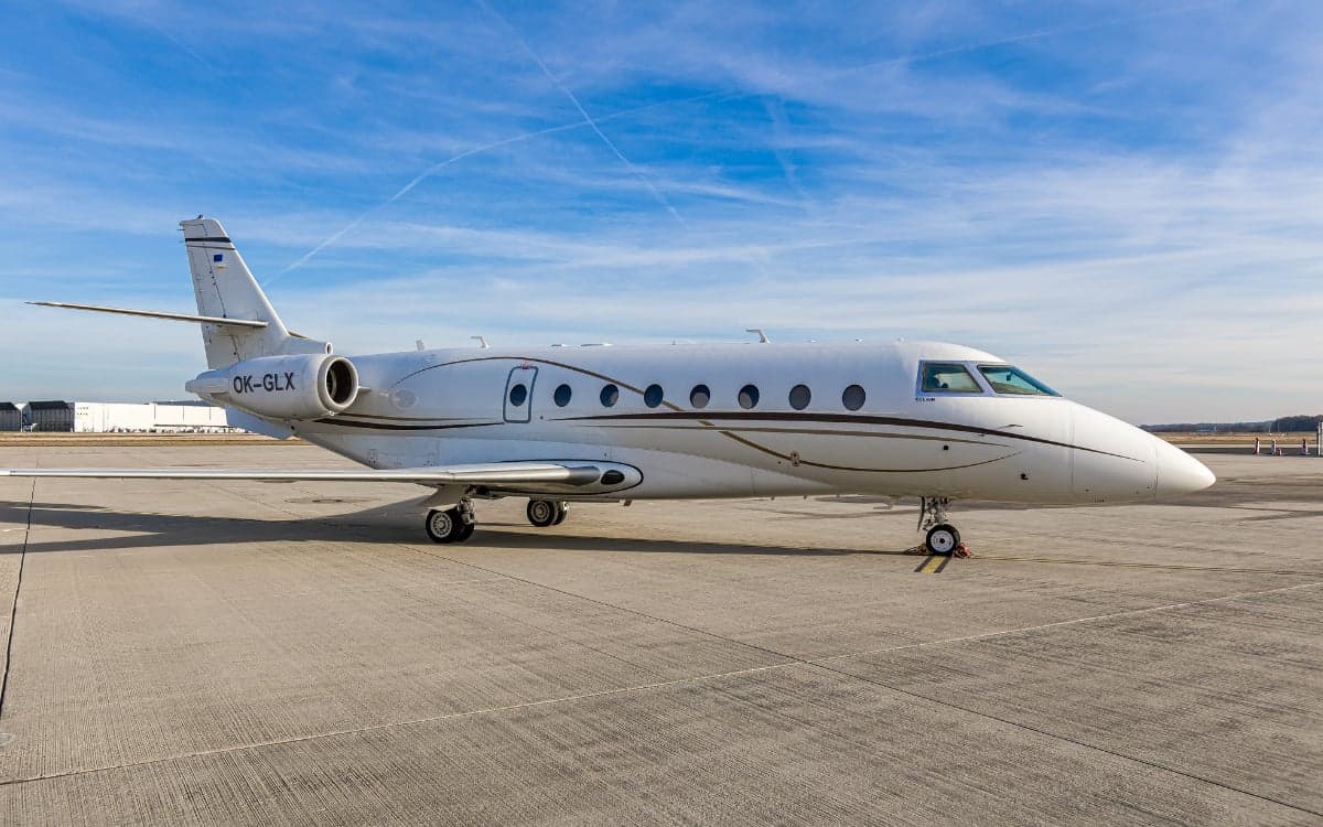 Gulfstream G200 aircraft with the tail number OK-GLX parked on the tarmac.