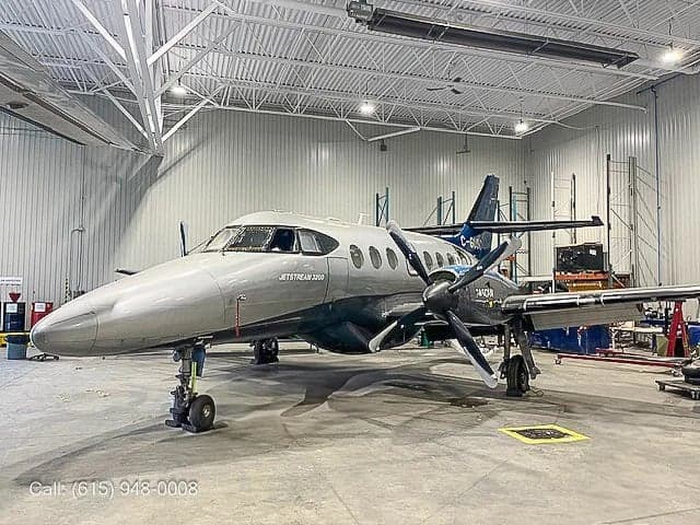 A Jetstream 3200 aircraft parked in a hangar.