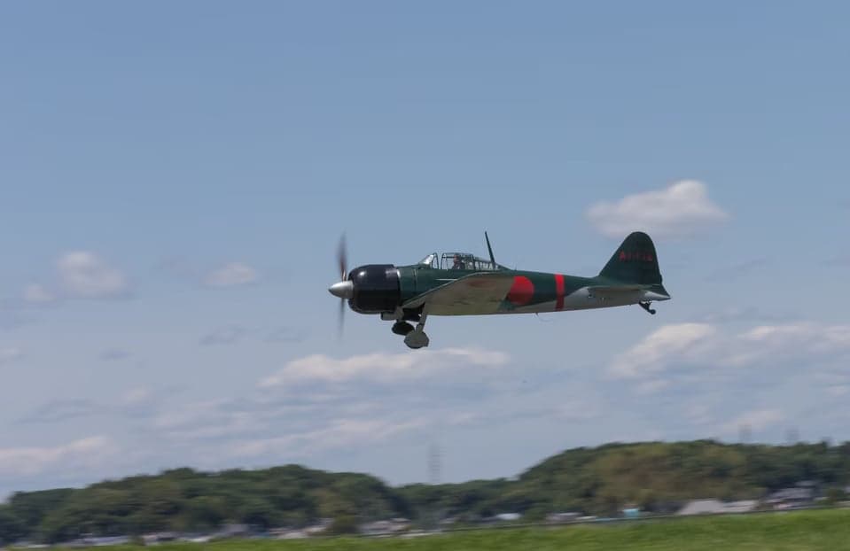 A Mitsubishi A6M Zero flying in the sky.