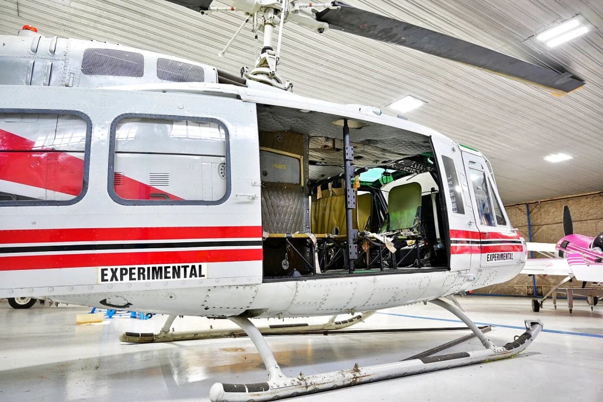 Side view of the N857SD helicopter showing the interior and cockpit.