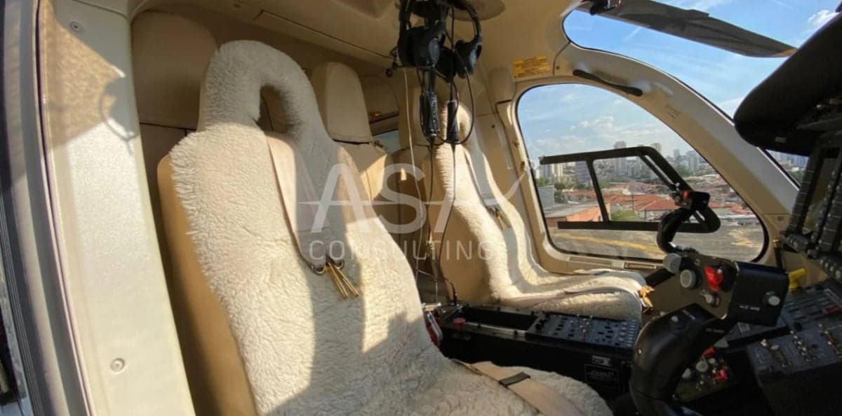 The interior of a helicopter with sheepskin seat covers.