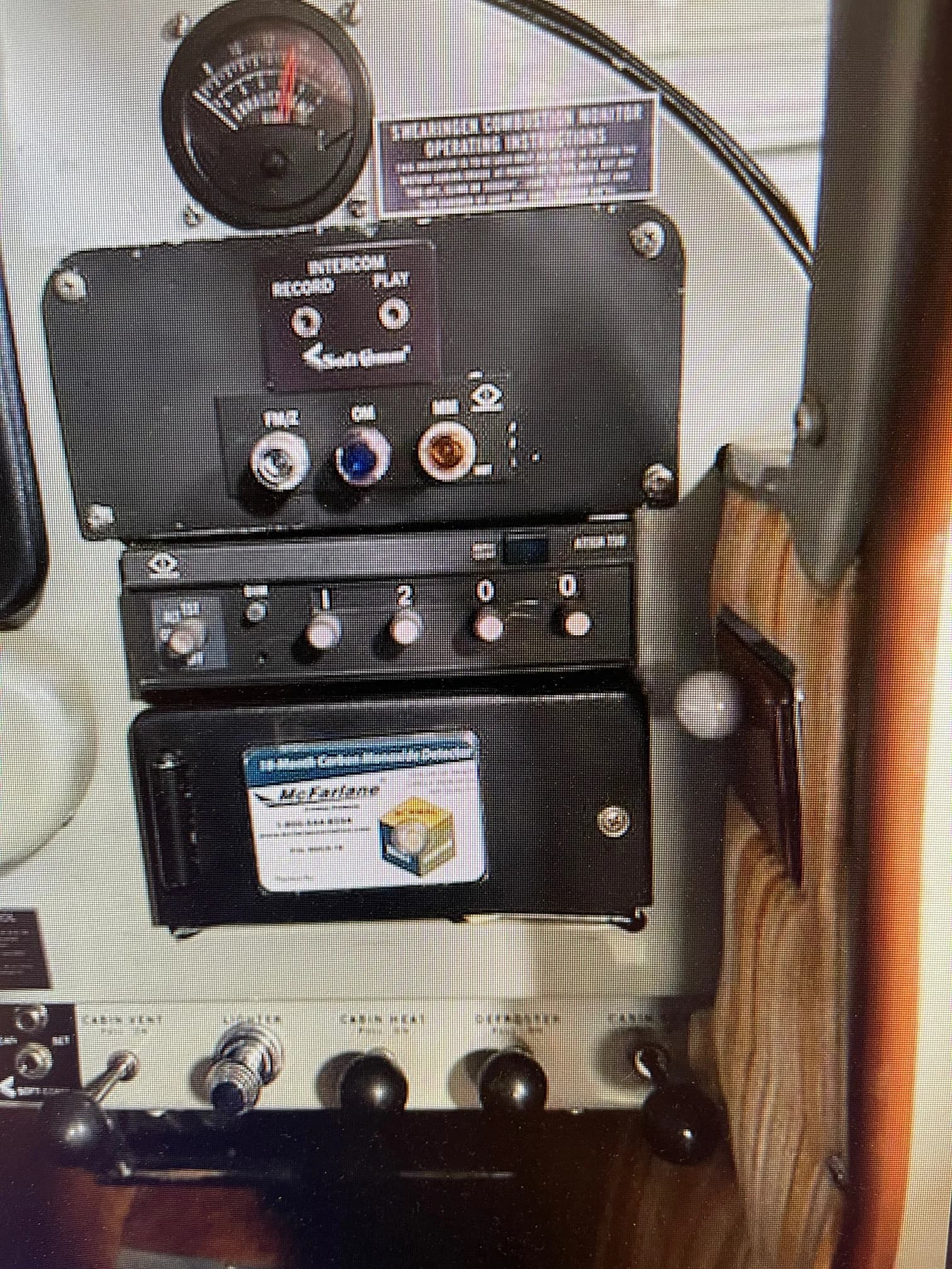 Close-up of the aircraft's cockpit controls and instruments, including the intercom and cabin controls.