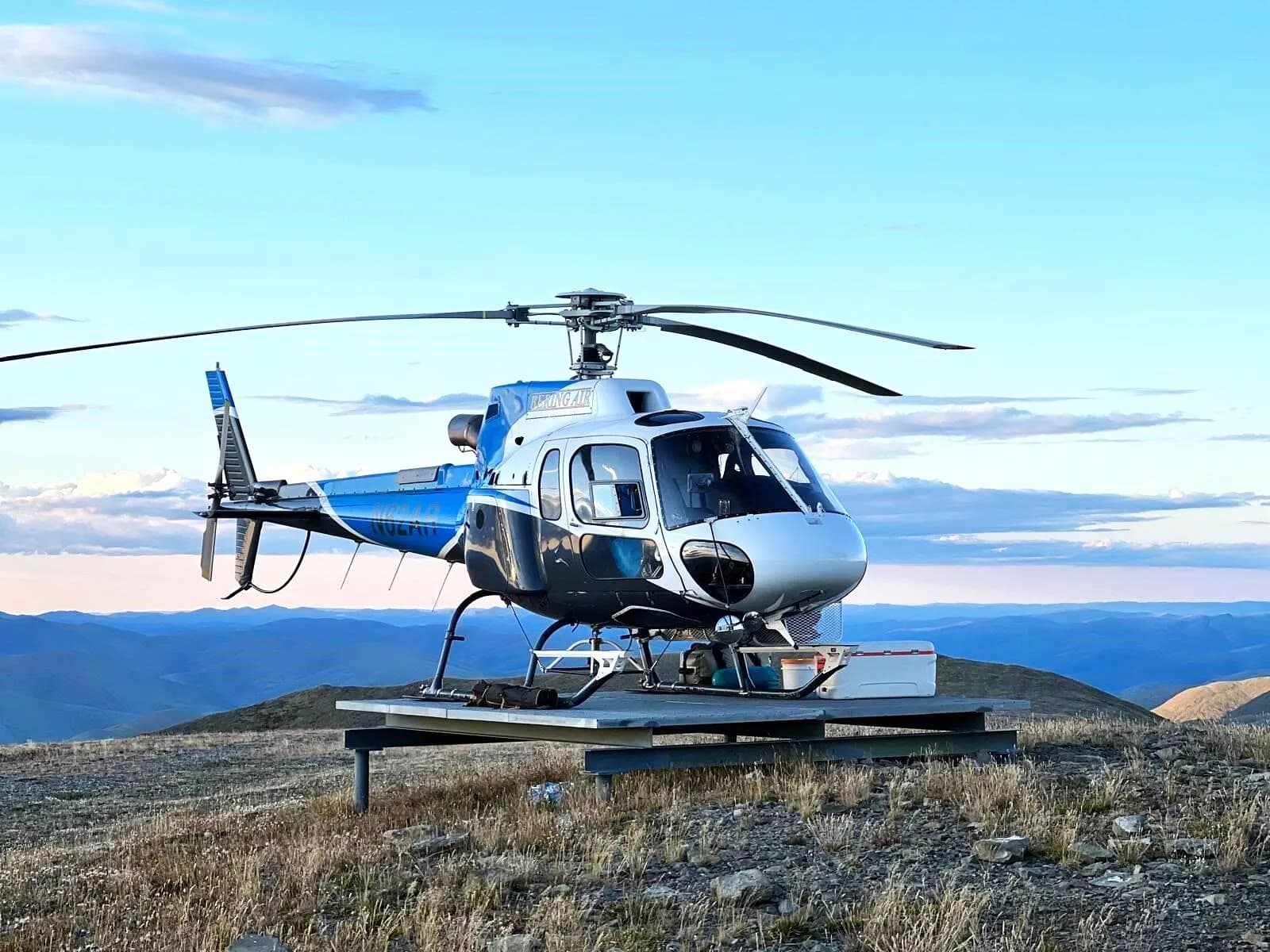 N62AR helicopter on a platform with a mountain view.